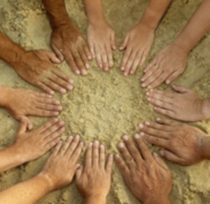 Summer fun. Twelve hands form a circle over the sand. Useful to represent diversity, human nature, teamwork etc. There are male and female hands, different skin colours and ages. Ones have rings and one has a band aid.